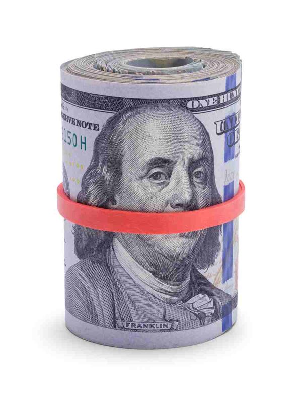 Rolled-up stack of one hundred dollar bills held with a red rubber band, representing the escrow shortage a higher insurance premium can create